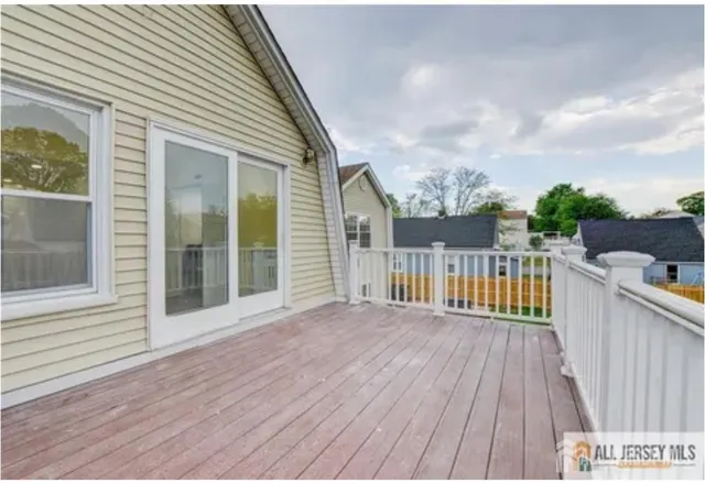 a view of a wooden deck with a yard
