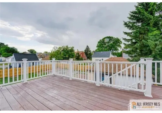 a balcony with wooden floor and fence