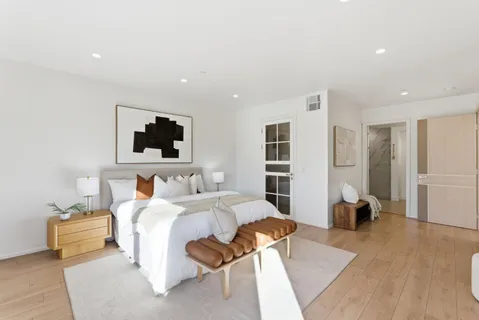 a bedroom with furniture and a flat screen tv