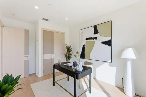 a living room with furniture and a potted plant
