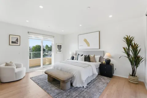 a bedroom with a bed and a large window