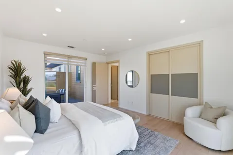 a bedroom with a large bed and a couch