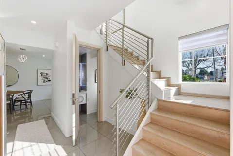 a view of entryway and hall with wooden floor