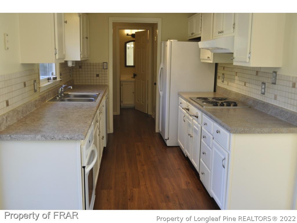 410 Saddle Ridge Road Fayetteville, NC 28311 - Photo 12 of 31 a kitchen with stainless steel appliances granite countertop a sink stove and refrigerator