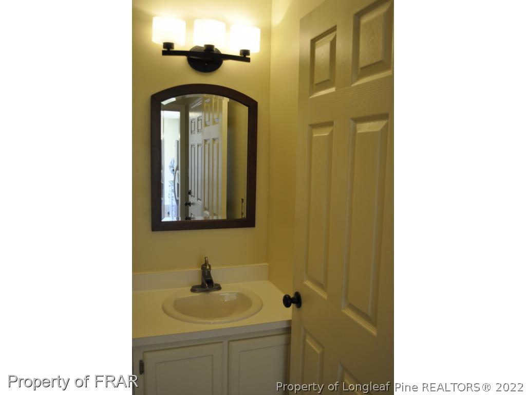 410 Saddle Ridge Road Fayetteville, NC 28311 - Photo 13 of 31 a bathroom with a sink and a mirror