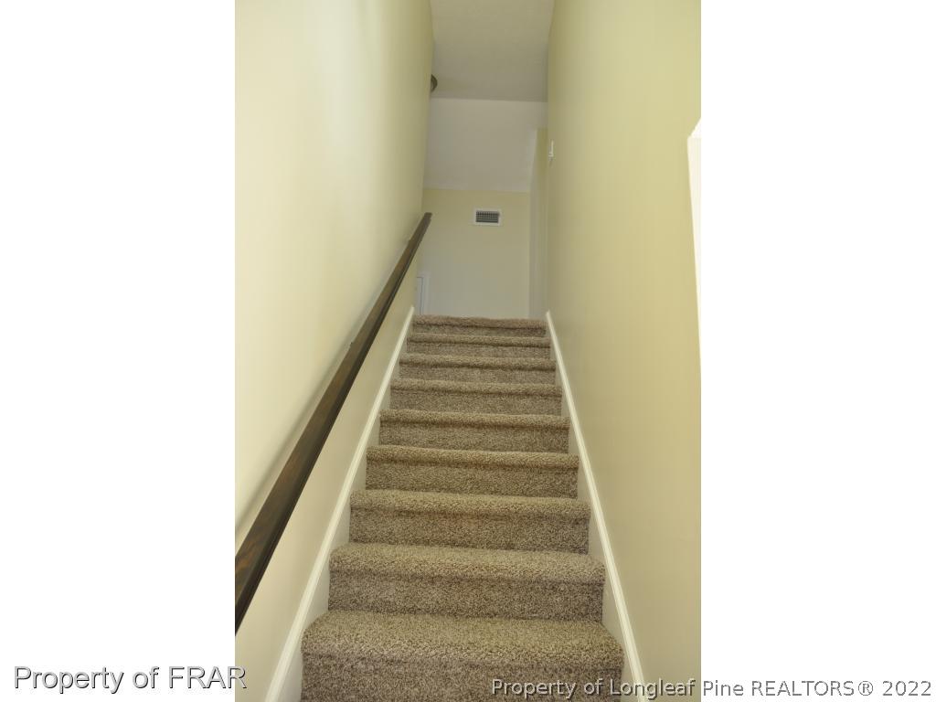 410 Saddle Ridge Road Fayetteville, NC 28311 - Photo 16 of 31 a view of a hallway with staircase