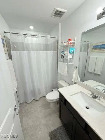 a bathroom with a double vanity sink and mirror
