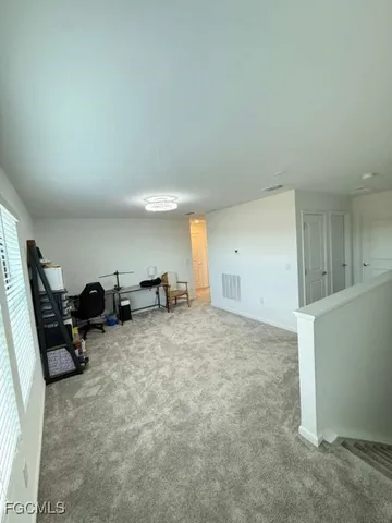 a view of walk in closet with clothes