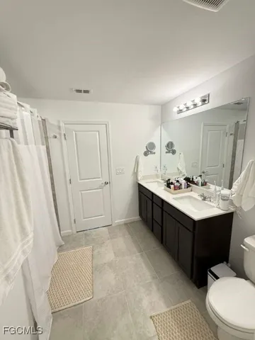 a bedroom with a bed and a large mirror