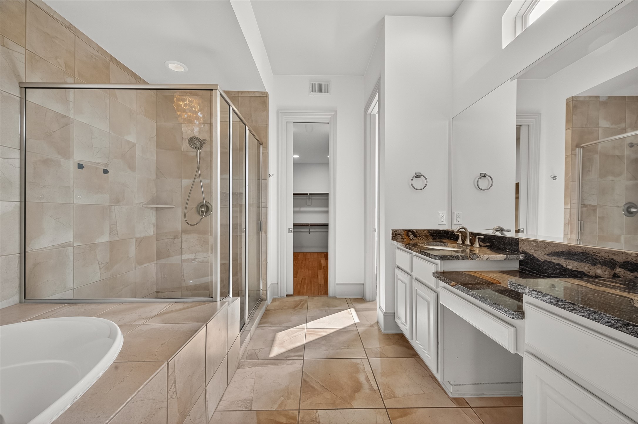 931 West 23rd Street, Unit K Houston, TX 77008 - Photo 18 of 40 Separate shower with bench seat and tile surround. Bathroom is 12'8" x 10'8".