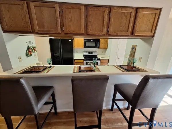 a kitchen with a table chairs and cabinets