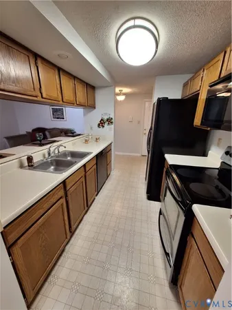 a kitchen with stainless steel appliances a sink stove and cabinets