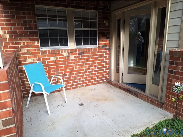 a view of a door with a chair and table