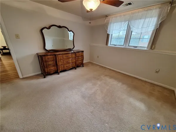 a living room with furniture and a mirror