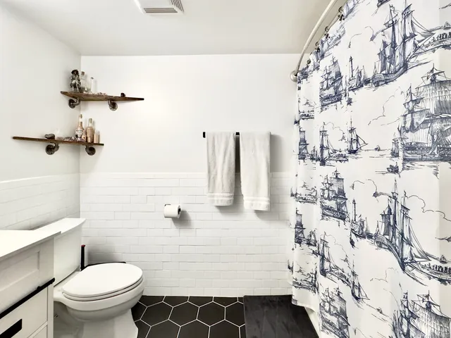 a bathroom with a sink toilet and shower