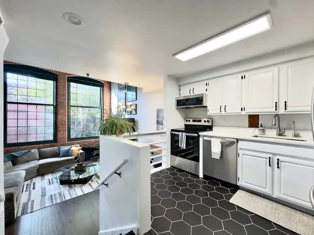 a kitchen with a stove a sink and a microwave