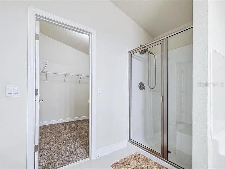 404 Rio Grande Court Poinciana, FL 34759 - Photo 13 of 21 a bathroom with a shower and a glass door