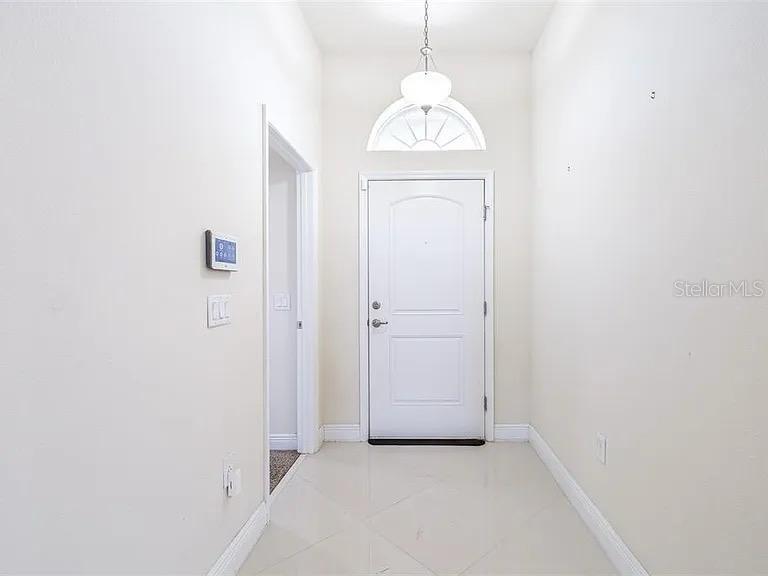 404 Rio Grande Court Poinciana, FL 34759 - Photo 6 of 21 an empty room with wooden floor cabinet and a view