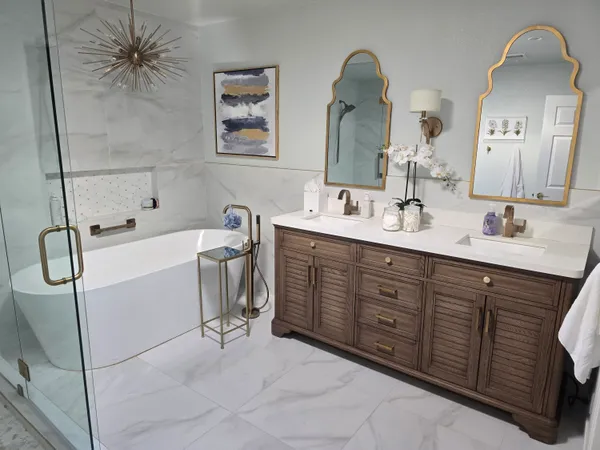 a spacious bathroom with a double vanity sink a mirror and a shower