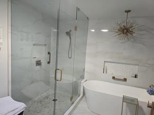 a white bath tub sitting next to a shower