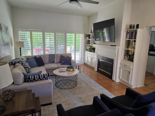 a living room with fireplace furniture and a flat screen tv