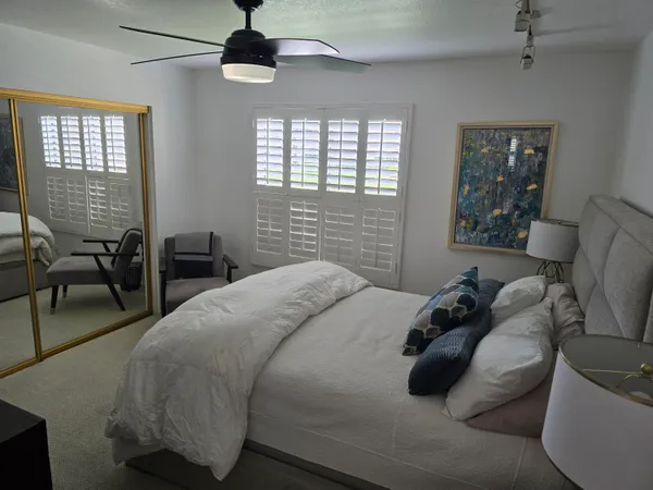 a bedroom with a bed a couch and dresser