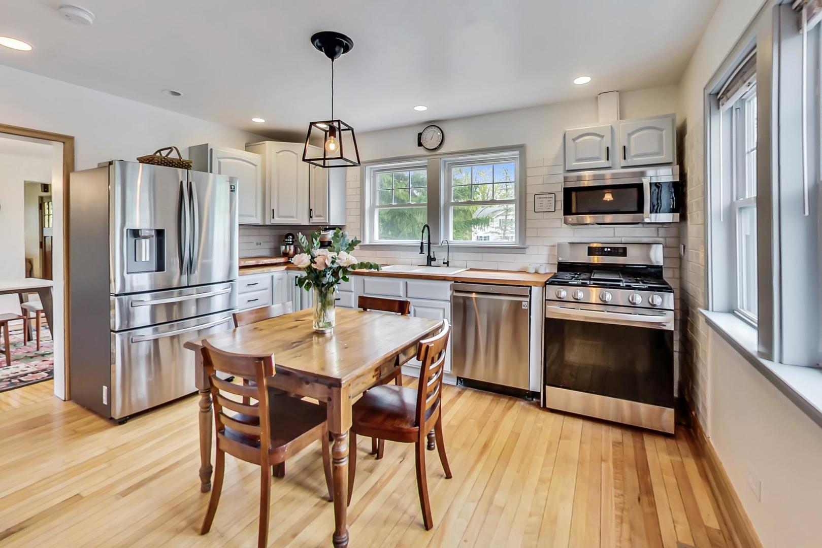 20792 Illinois Rte 59 Barrington, IL 60010 - Photo 12 of 35 a kitchen with stainless steel appliances a stove a sink refrigerator and microwave