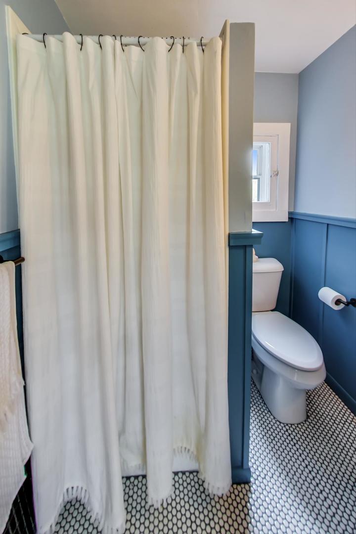 20792 Illinois Rte 59 Barrington, IL 60010 - Photo 18 of 35 a bathroom with a toilet and a shower curtain