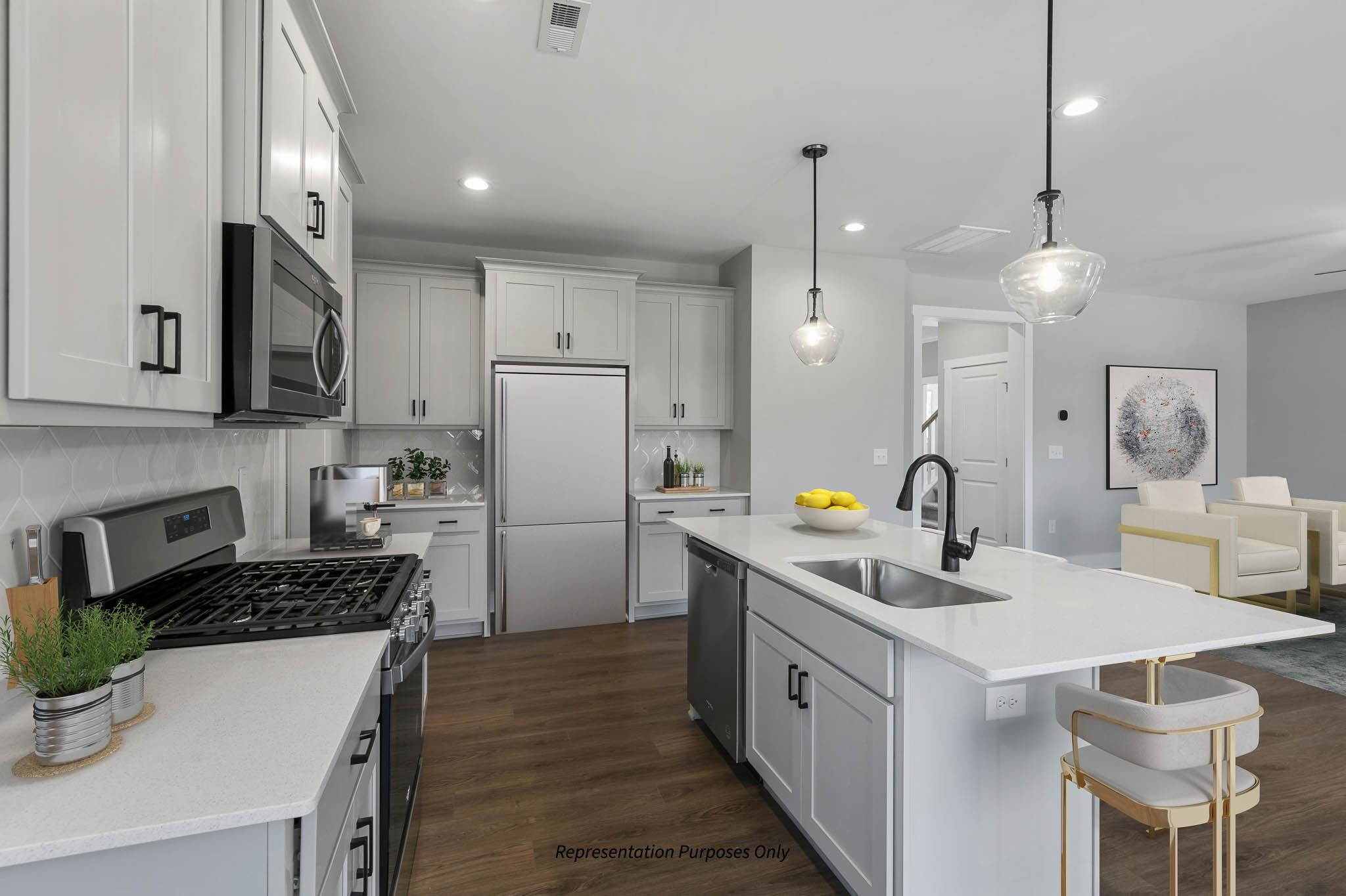 142 Beacon Hl Road Lillington, NC 27546 - Photo 16 of 38 a kitchen with a sink a refrigerator and chairs