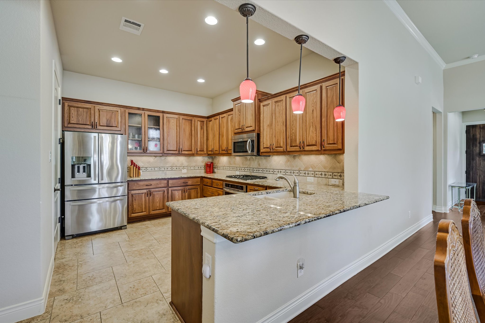 103 Rivalto Circle, Unit 1 Lakeway, TX 78734 - Photo 7 of 34 Kitchen with granite counters and tile floor