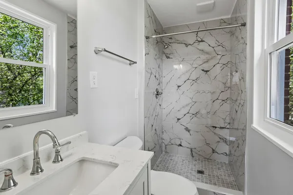 a bathroom with a sink toilet and shower
