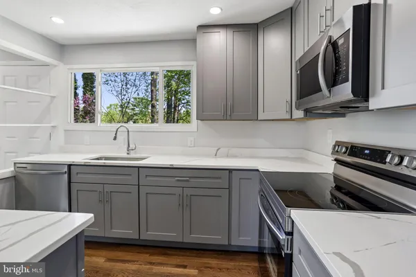 a kitchen with a sink stove and cabinets