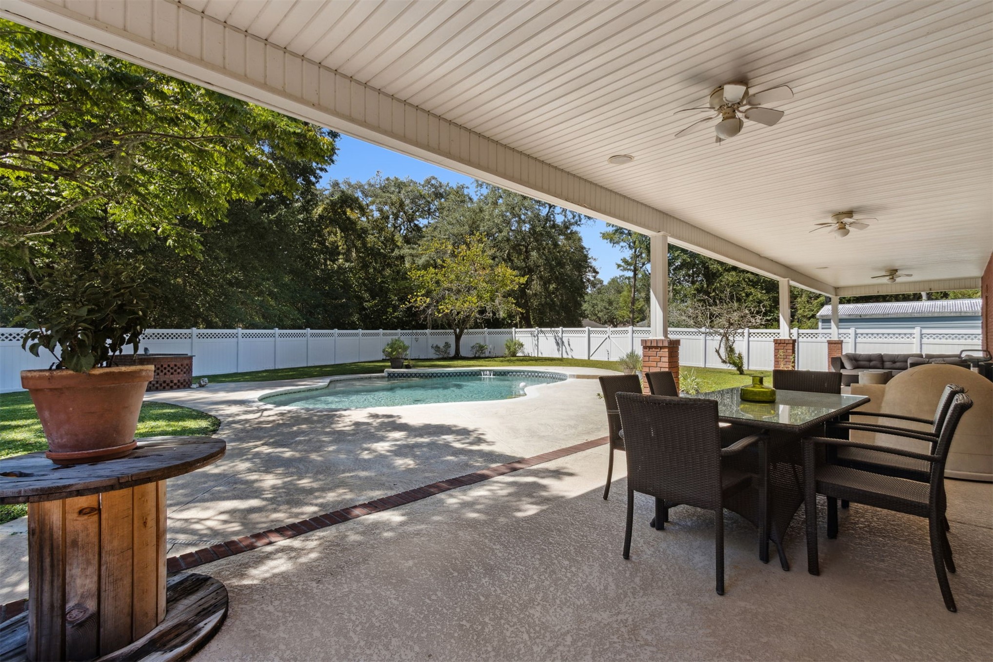 87377 Raddin Road Yulee, FL 32097 - Photo 62 of 75 a view of a patio with table and chairs and potted plants