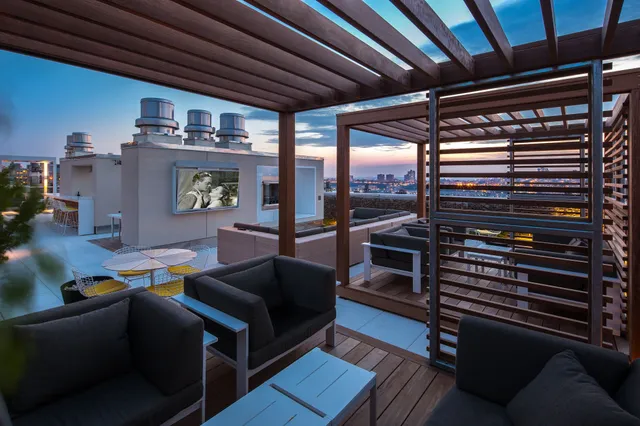 a view of a balcony with many windows and plants
