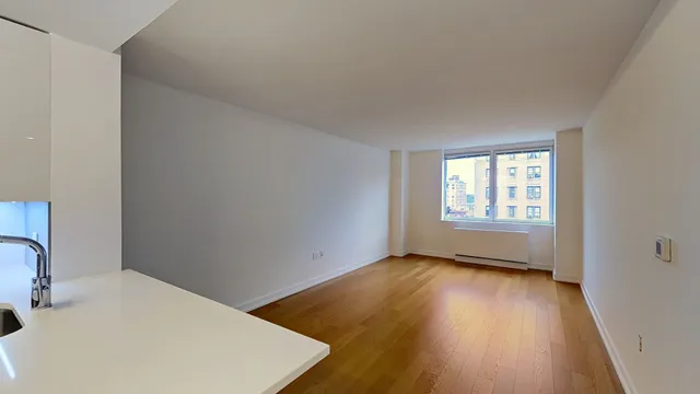 a view of living room with furniture and wooden floor