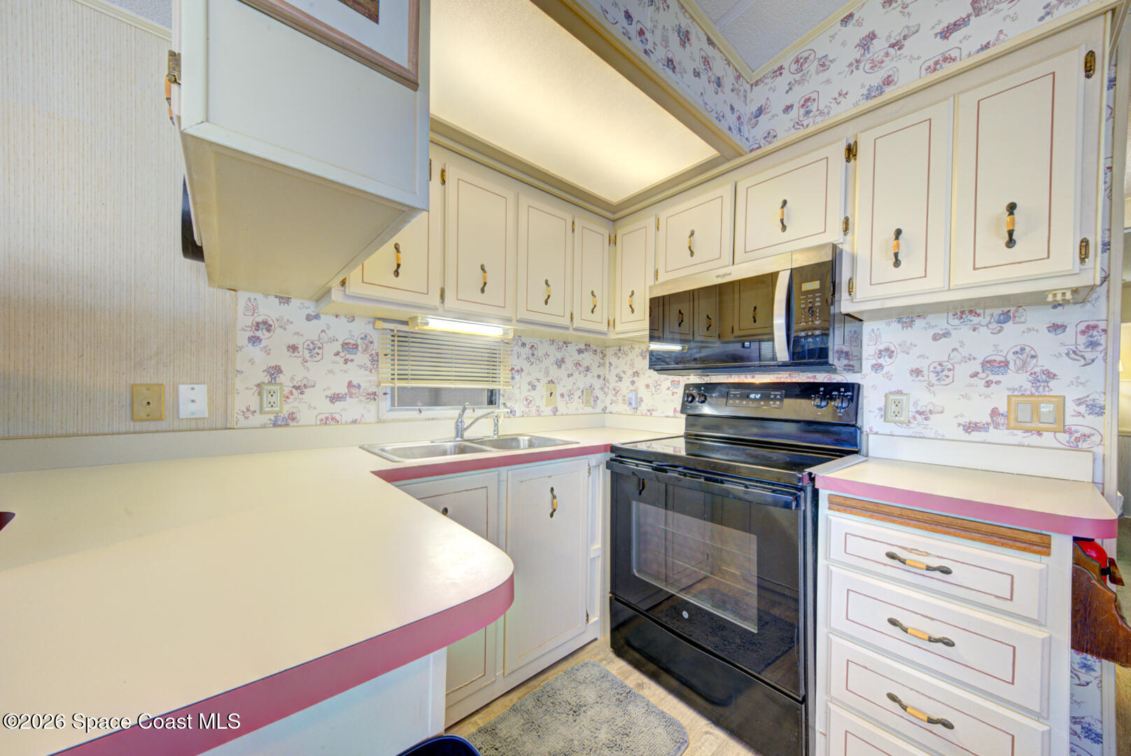 283 Buffalo Place Rockledge, FL 32955 - Photo 17 of 23 a kitchen with stainless steel appliances a stove a sink and a microwave