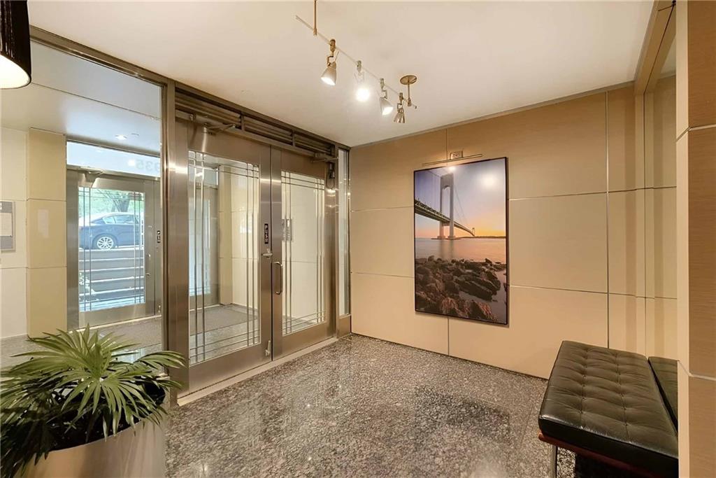 9935 Shore Road, Unit 6B Brooklyn, NY 11209 - Photo 1 of 9 a view of a hallway with wooden floor and a potted plant
