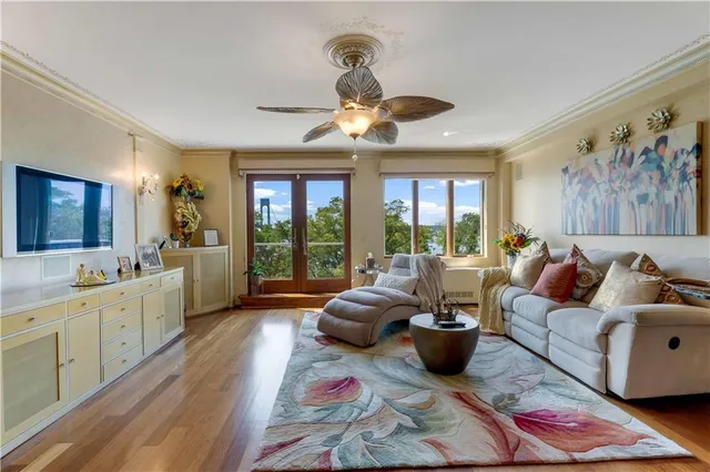 a living room with furniture large window and flat screen tv