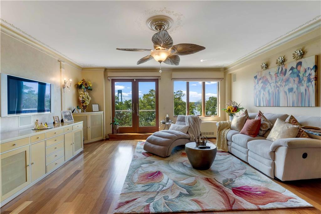 9935 Shore Road, Unit 6B Brooklyn, NY 11209 - Photo 2 of 9 a living room with furniture large window and flat screen tv