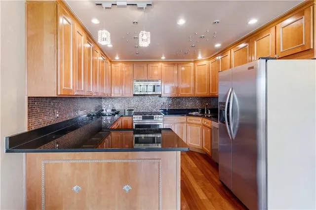 a kitchen with a sink a refrigerator and cabinets