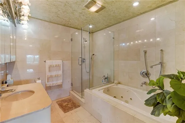 a bathroom with a tub a sink and mirror