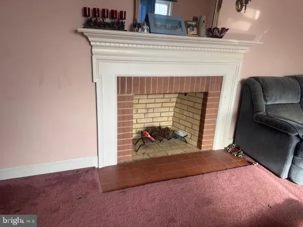 a view of livingroom with furniture and a fireplace