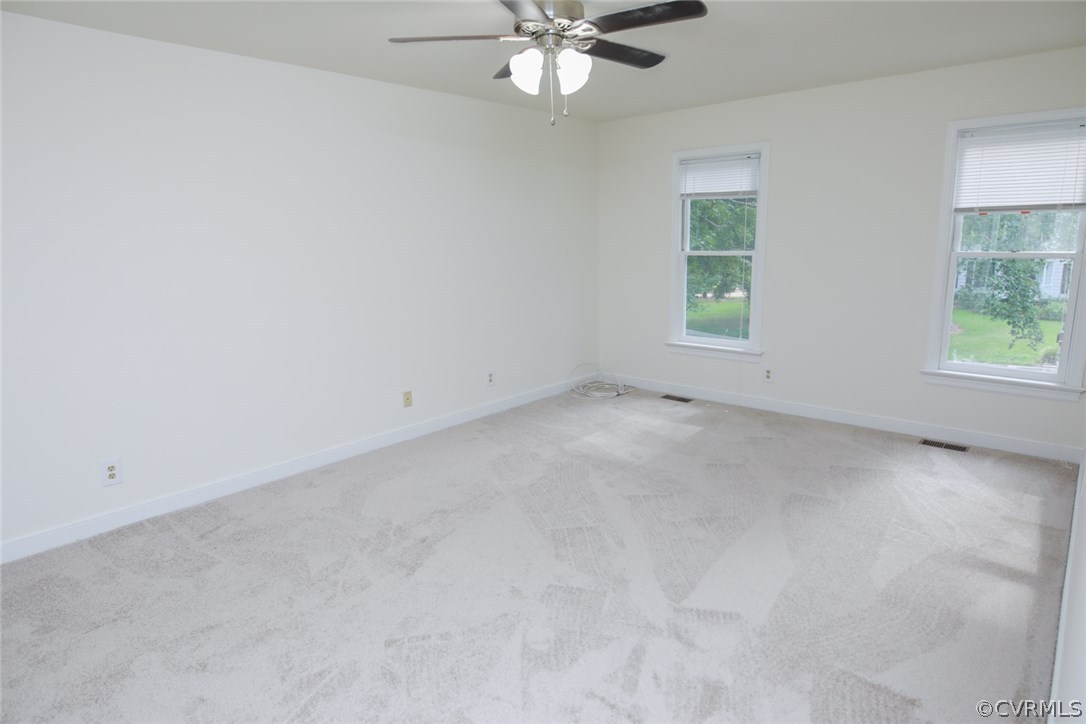 3003 Cove Ridge Road Midlothian, VA 23112 - Photo 17 of 33 an empty room with windows and chandelier fan