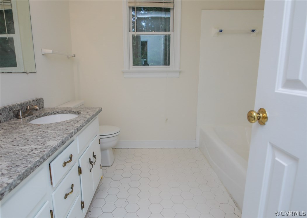 3003 Cove Ridge Road Midlothian, VA 23112 - Photo 19 of 33 a bathroom with a granite countertop sink a toilet and mirror
