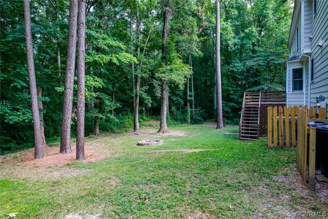 3003 Cove Ridge Road Midlothian, VA 23112 - Photo 26 of 33 a view of a backyard with plants and large trees
