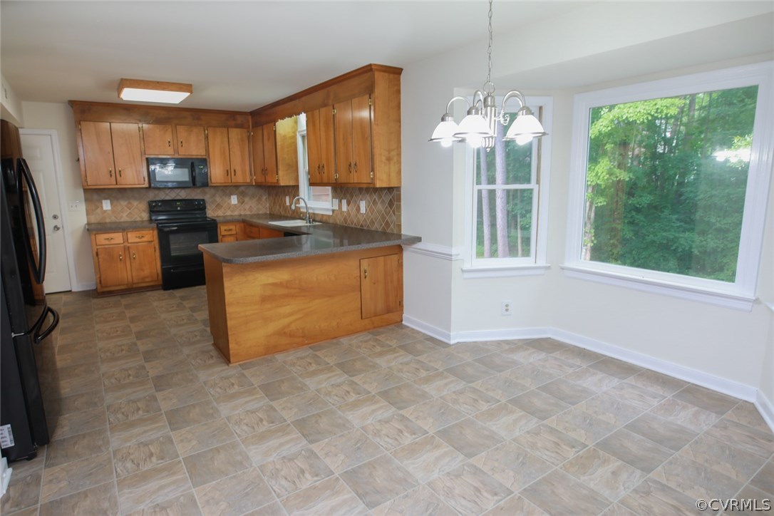 3003 Cove Ridge Road Midlothian, VA 23112 - Photo 10 of 33 a kitchen with stainless steel appliances granite countertop a stove a sink and a refrigerator
