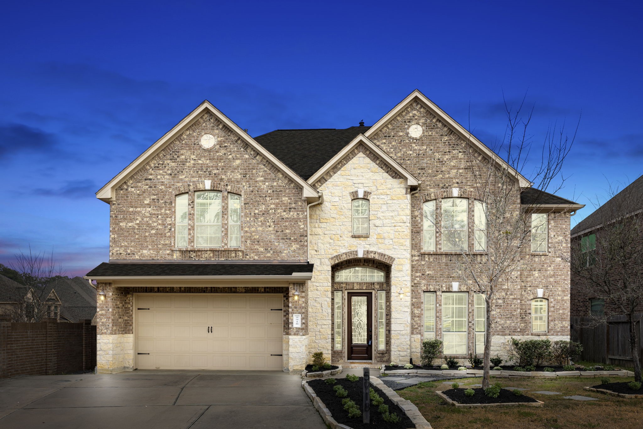 a front view of a house with a garden