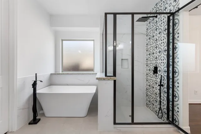a bathroom with a bathtub and a shower