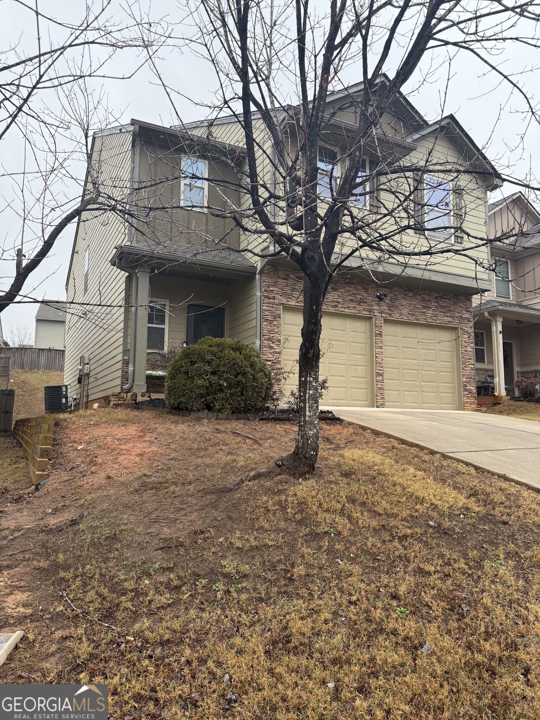 4815 Longview Run Decatur, GA 30035 - Photo 3 of 25 a front view of a house with a yard and garage