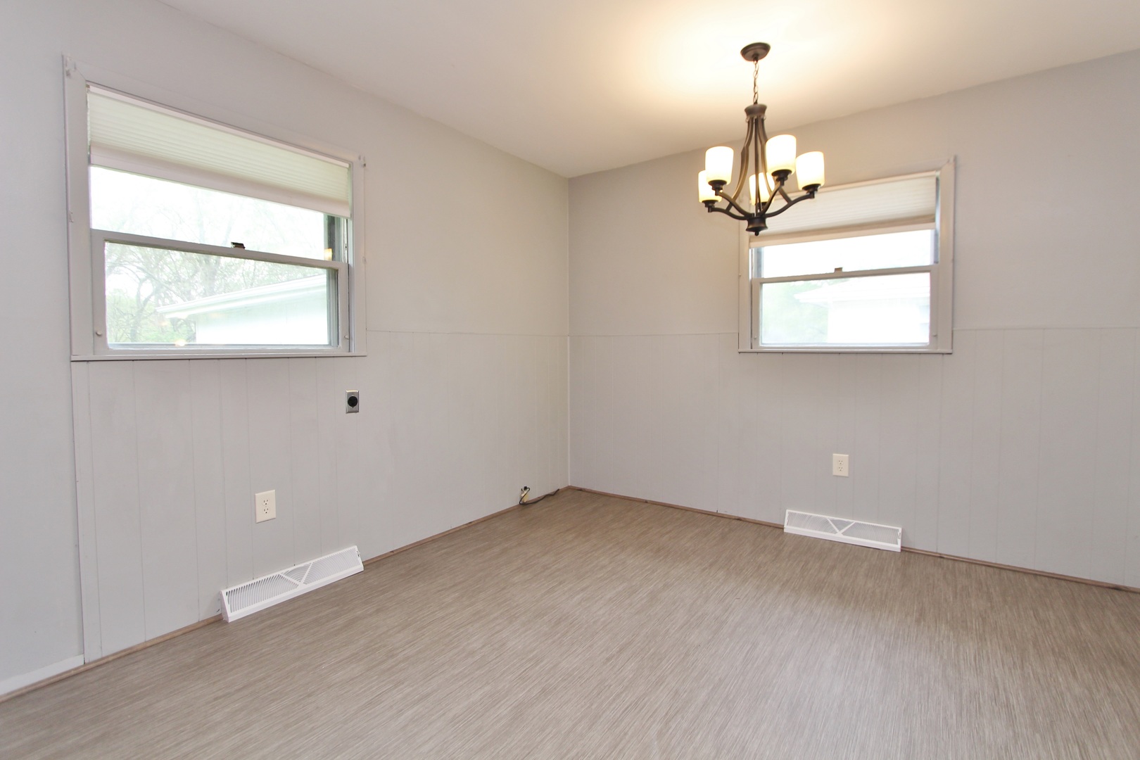 1222 Susan Circle Morris, IL 60450 - Photo 9 of 31 an empty room with chandelier fan and windows